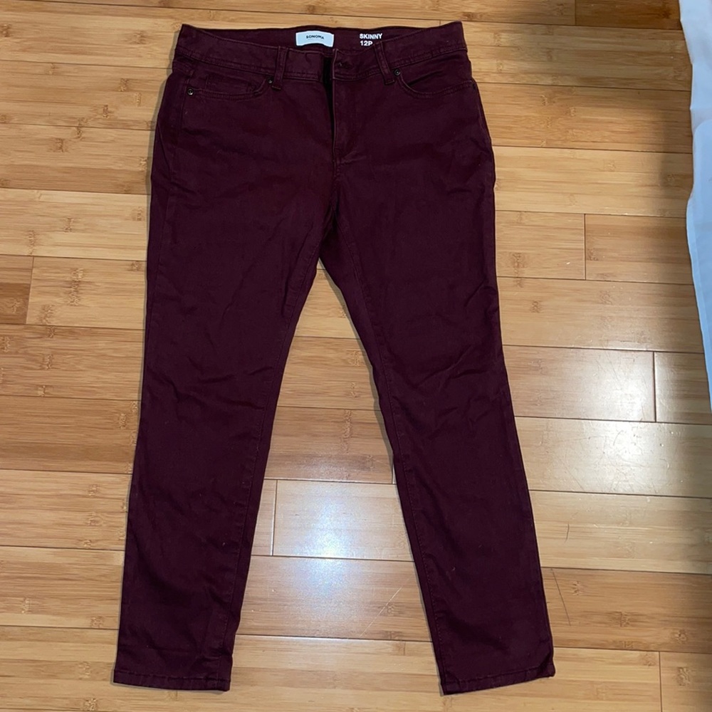 Burgundy skinny jeans.
